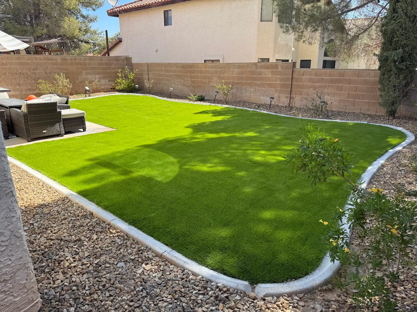 Gravel edging and base prep beneath artificial turf in a Henderson backyard