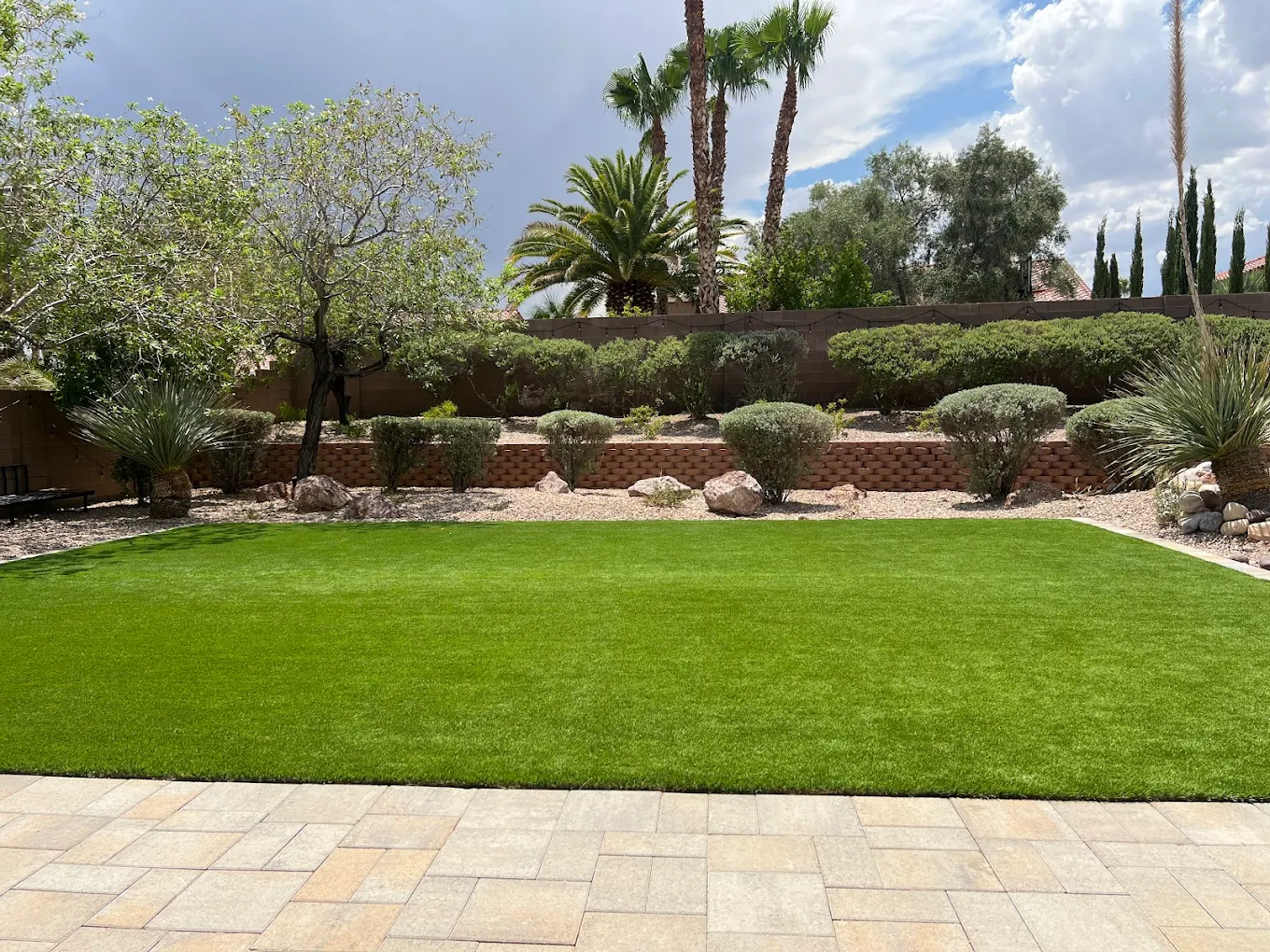 Clean artificial turf with desert landscaping in Henderson