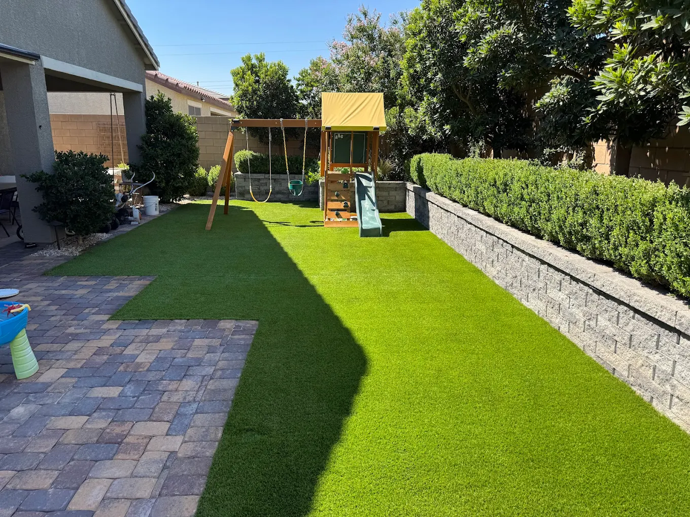 Family backyard with clean turf and play area