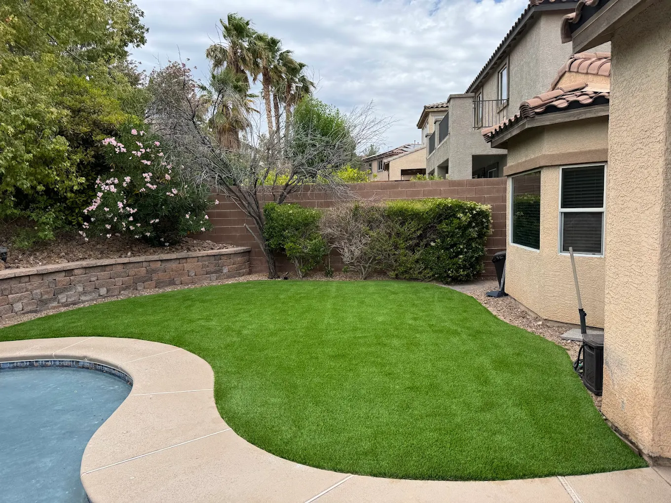 Artificial turf next to pool area in Henderson home